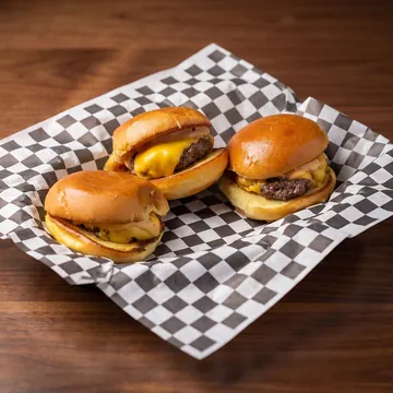 Three cheeseburger sliders on brioche buns
