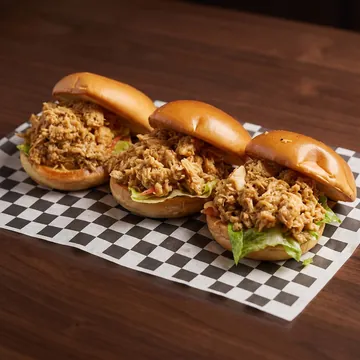 Three pulled chicken sliders on brioche buns